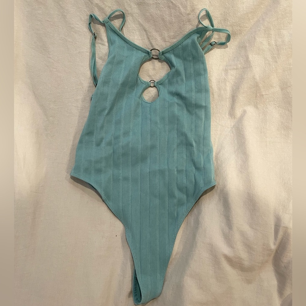 Out from under strappy body suit